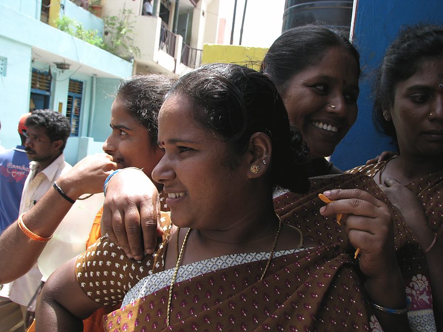 Women at a village gathering, mid-conversation